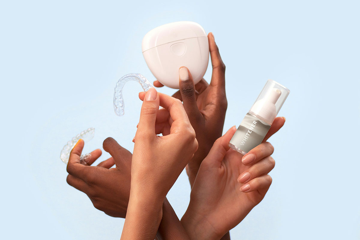 Multiple hands holding various dental care products, including clear aligners, a white retainer case, and a bottle labeled "WHITENER."