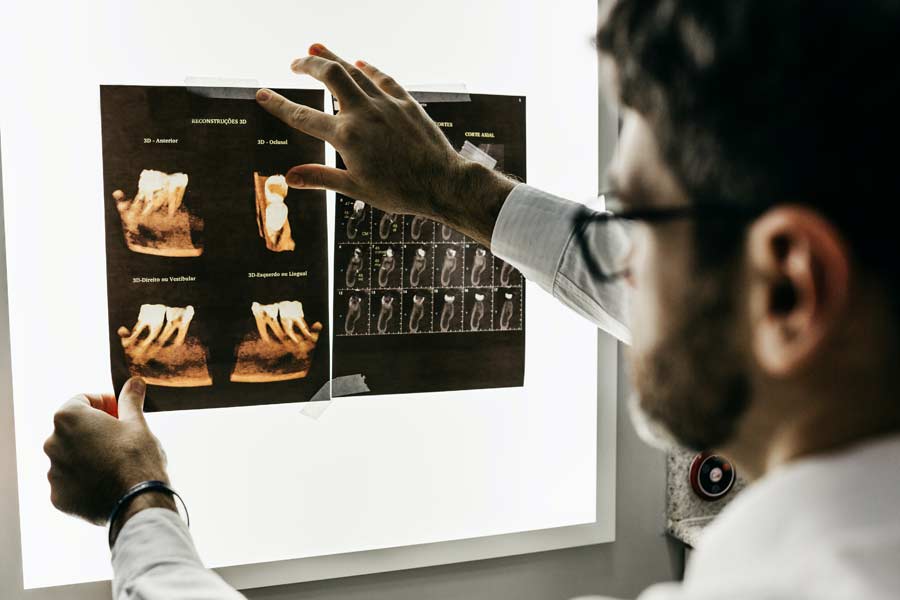 doctor examining dental x-rays