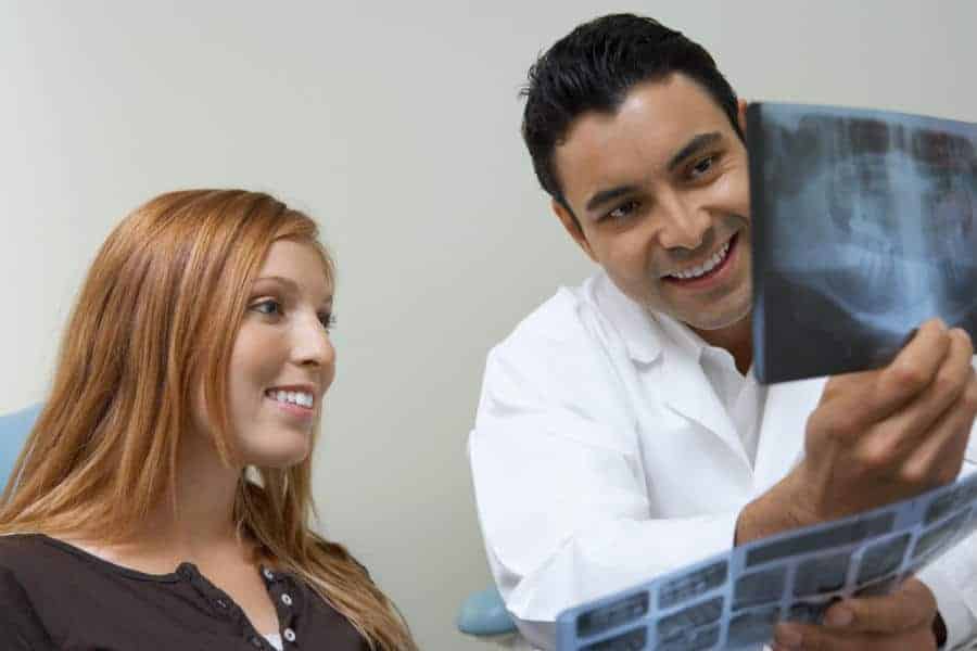 Finding the Right Dentist - Patient & Dentist Examining X-Rays